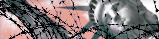 Blurred Statue of Liberty behind a tangle of barbed wire
