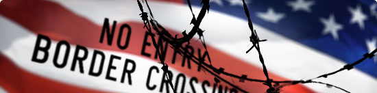 Blurred U.S. flag with barbed wire and "No Entry: Border Crossing" sign in foreground         