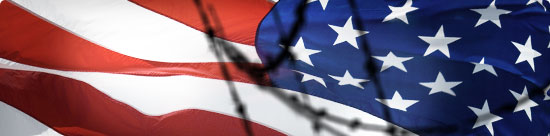 U.S. flag behind out-of-focus barbed wire